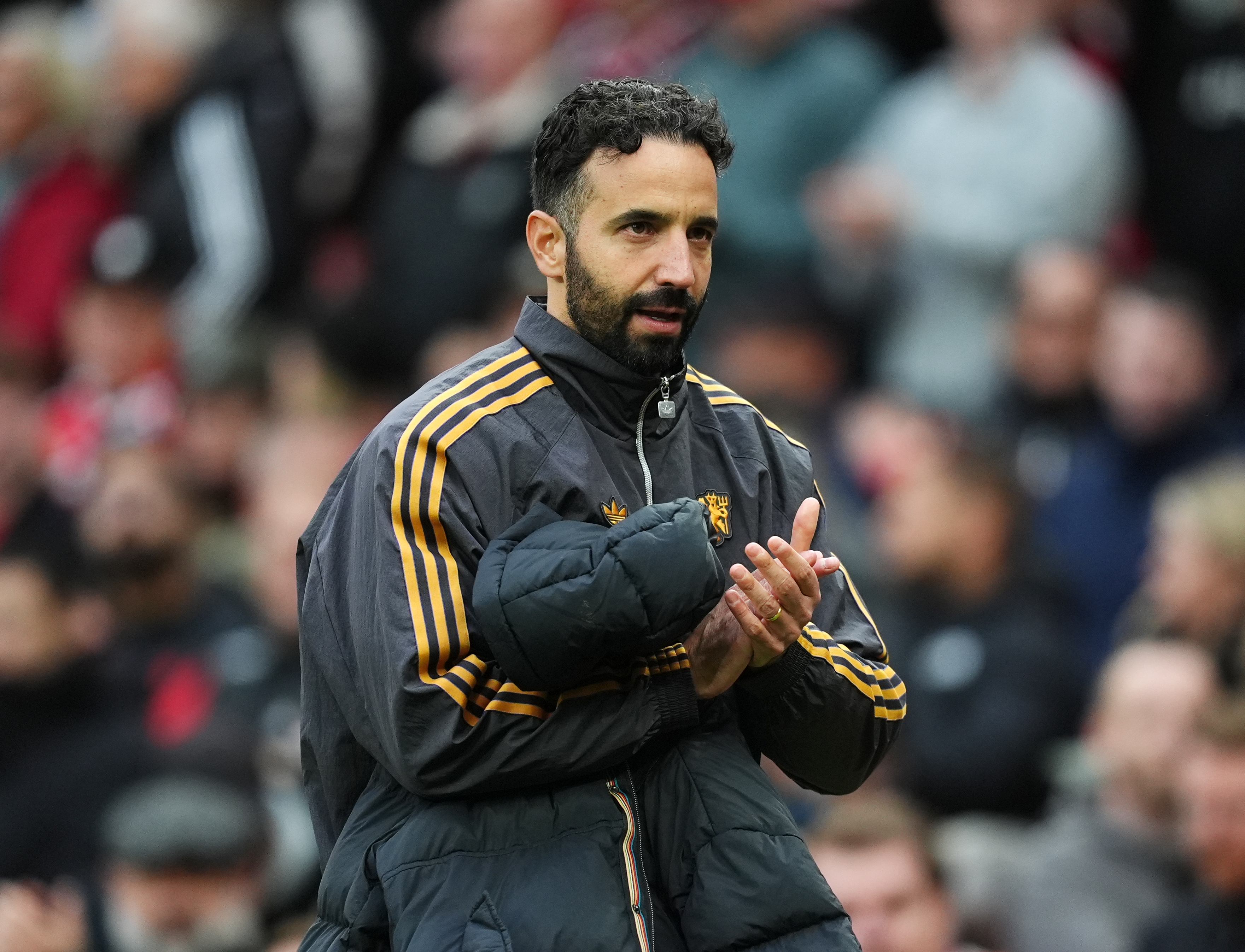 Manchester United manager Ruben Amorim clapping at full time.