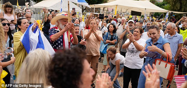 People reacts at Hostage Square in Tel Aviv on October 9, 2025, following news of a new Gaza ceasefire deal. Israel and Hamas on October 9 agreed a Gaza ceasefire deal to free the remaining living hostages, in a major step towards ending a war that has killed tens of thousands of people and unleashed a humanitarian catastrophe. (Photo by Maya LEVIN / AFP) (Photo by MAYA LEVIN/AFP via Getty Images)