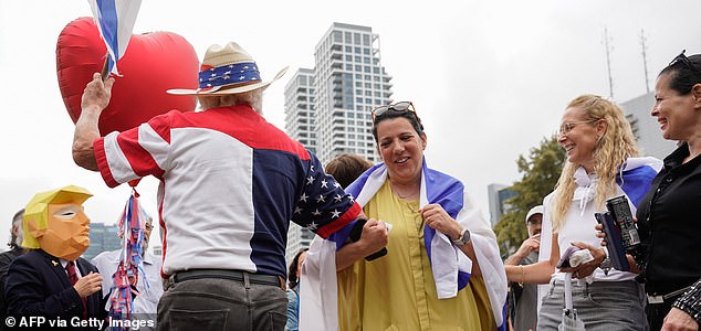 People reacts at Hostage Square in Tel Aviv on October 9, 2025, following news of a new Gaza ceasefire deal. Israel and Hamas on October 9 agreed a Gaza ceasefire deal to free the remaining living hostages, in a major step towards ending a war that has killed tens of thousands of people and unleashed a humanitarian catastrophe. (Photo by Maya LEVIN / AFP) (Photo by MAYA LEVIN/AFP via Getty Images)