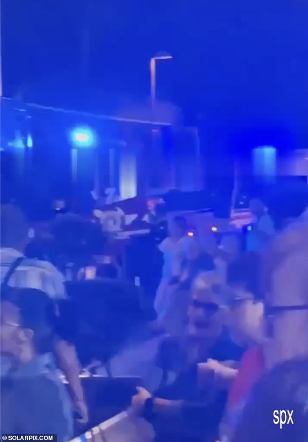 The evacuation order is said to have affected 490 guests including several Brits, pictured as they stood outside the hotel in the dark while firefighters entered and left the premises