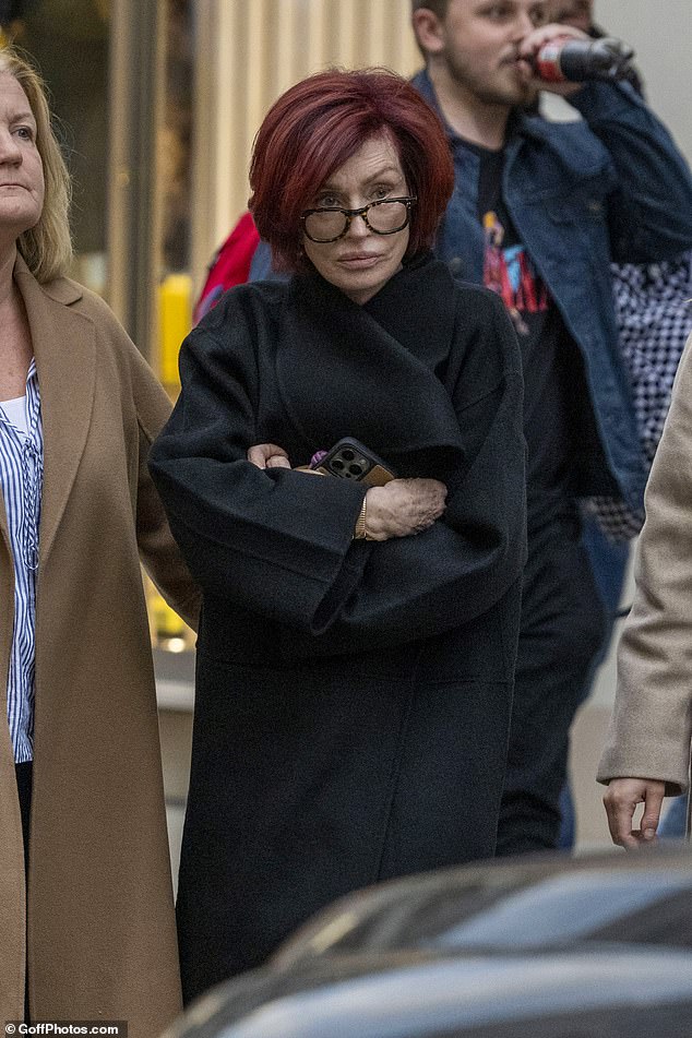 The style-conscious TV star was dressed in black jeans and a long black jacket and took the time to smile and chat to staff inside the shop