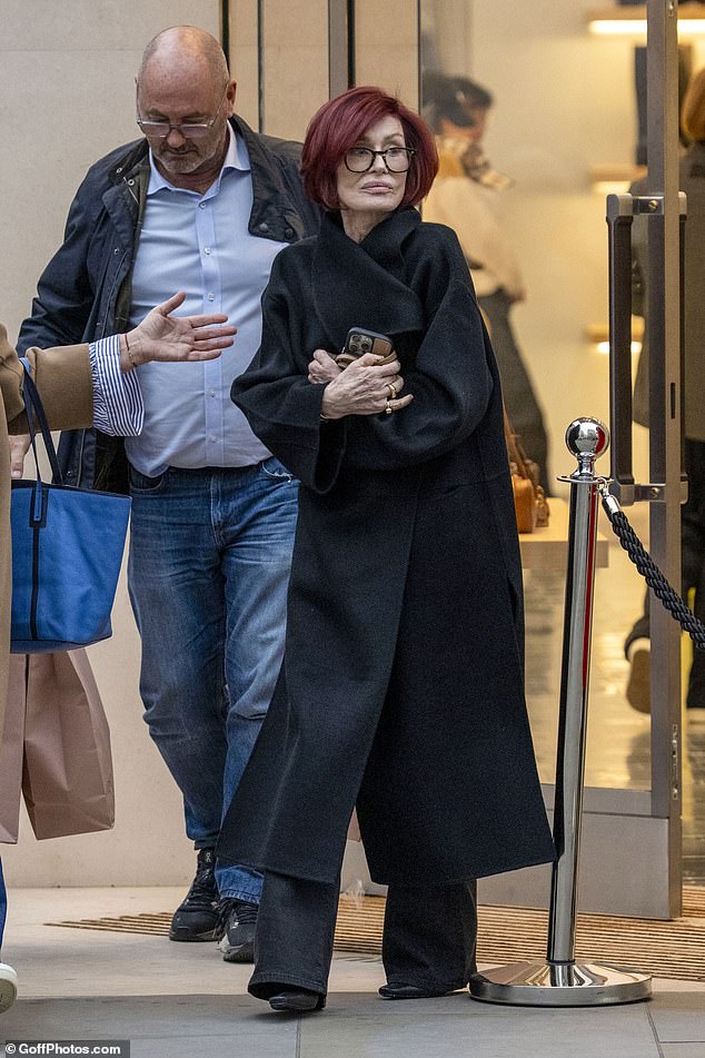 Frail-looking Sharon clutched her phone close to her chest as she was pictured leaving the store after her son Jack said she is 'not OK'
