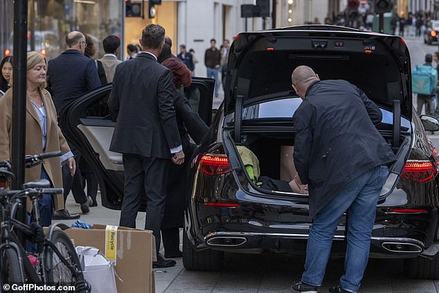 Security carried all her bags and packed them into a waiting car
