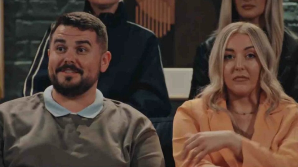 Dean and Sarah looking uncomfortable.