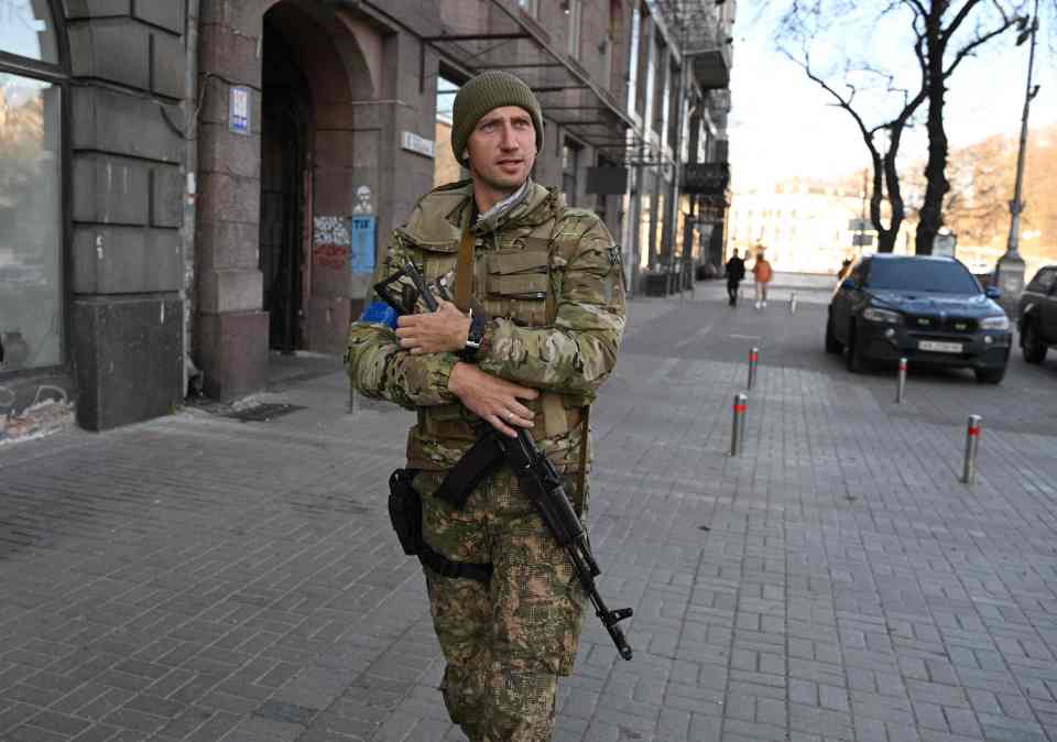Sergiy Stakhovsky in military fatigues and holding a Kalashnikov assault rifle in Kyiv.