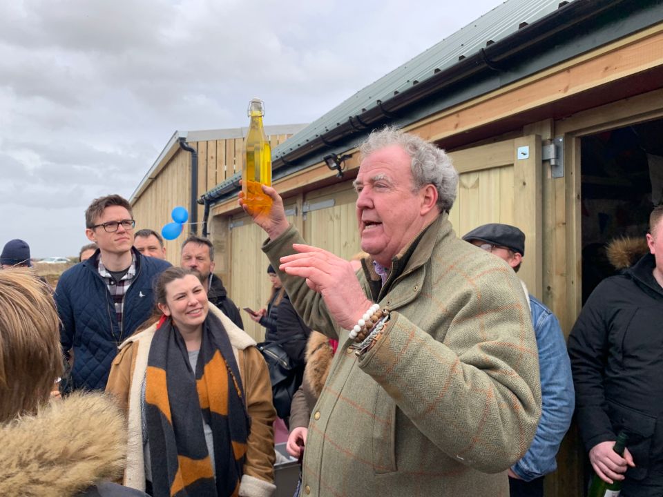 Jeremy Clarkson raffling water outside The Squat Shop, on his farm, Diddly Squat.
