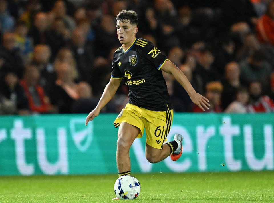 Shea Lacey of Manchester United dribbles the ball during the EFL Vertu Trophy match.
