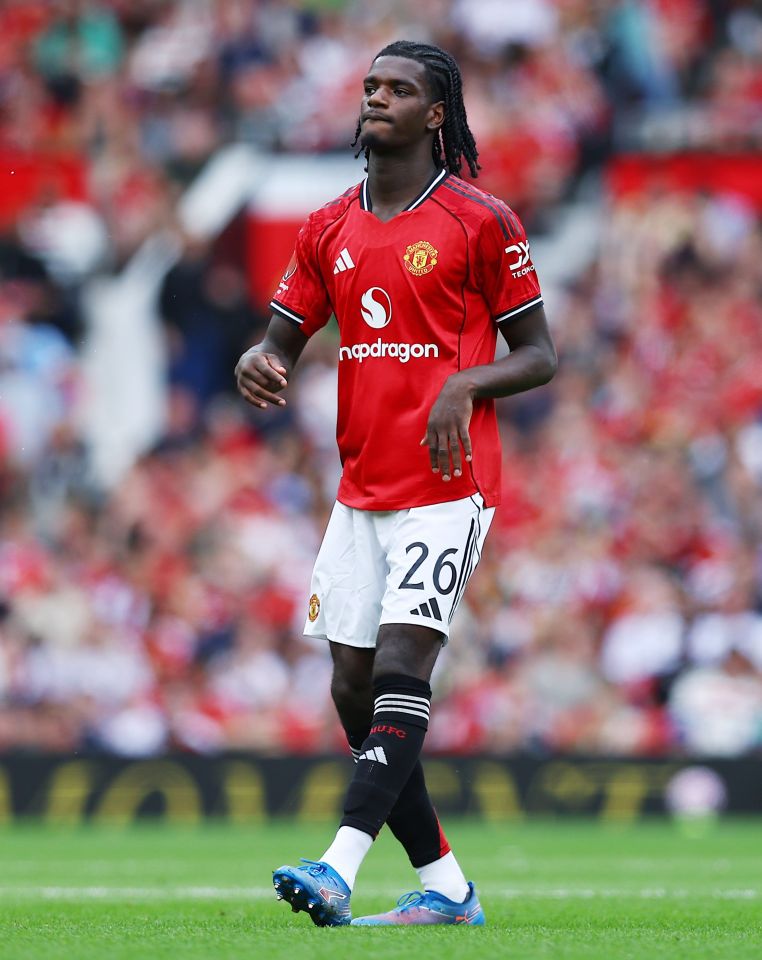 Ayden Heaven of Manchester United in a red and white uniform on a soccer field.