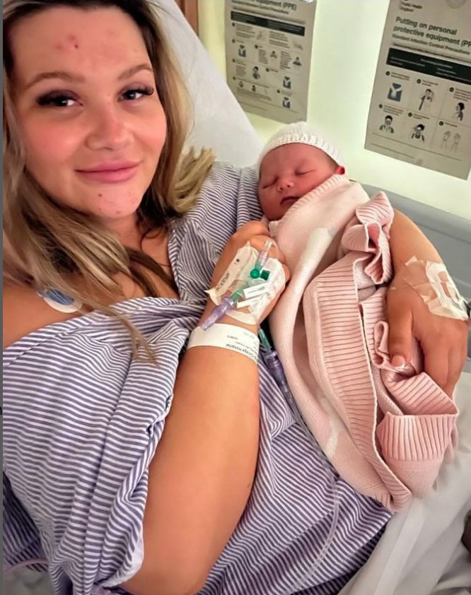 Shaughna Phillips holding her newborn baby in a hospital bed.