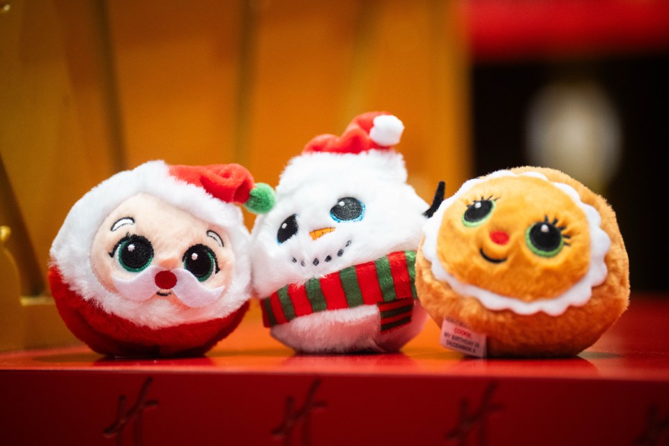 Three Christmas-themed plush toy balls: Santa, a snowman, and a gingerbread cookie.