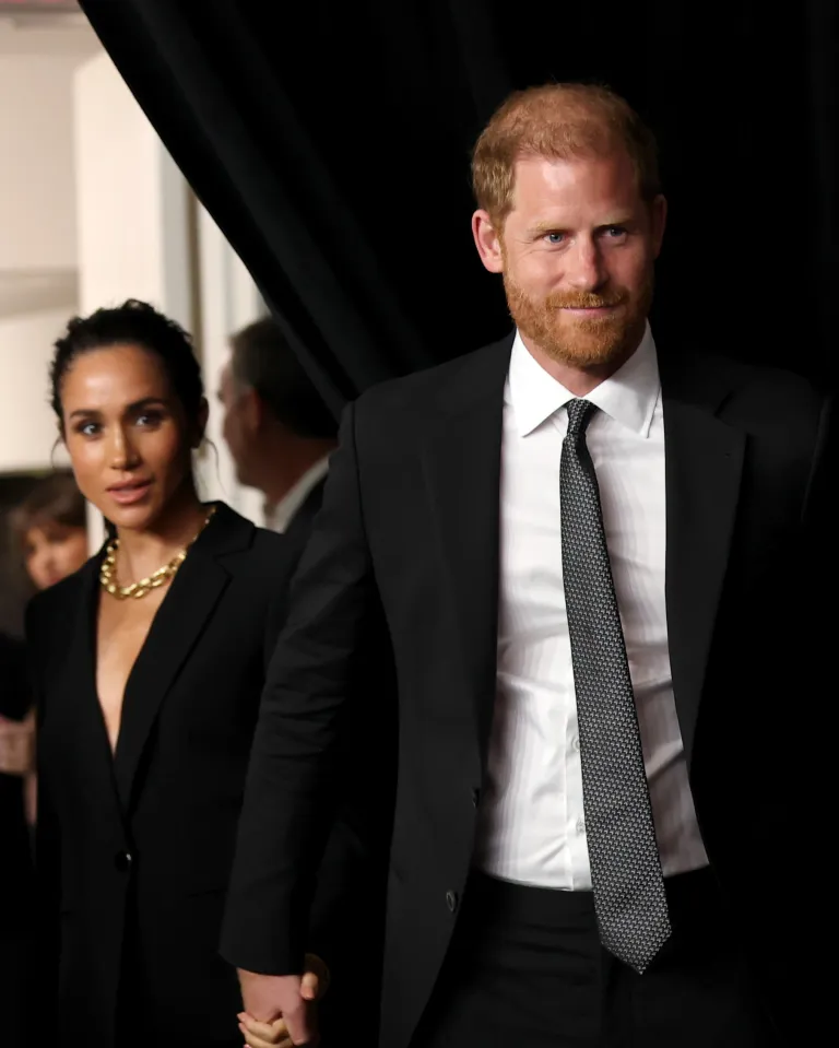 Prince Harry and Meghan Markle entering an event.