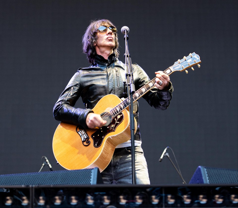 Richard Ashcroft performing with an acoustic guitar.