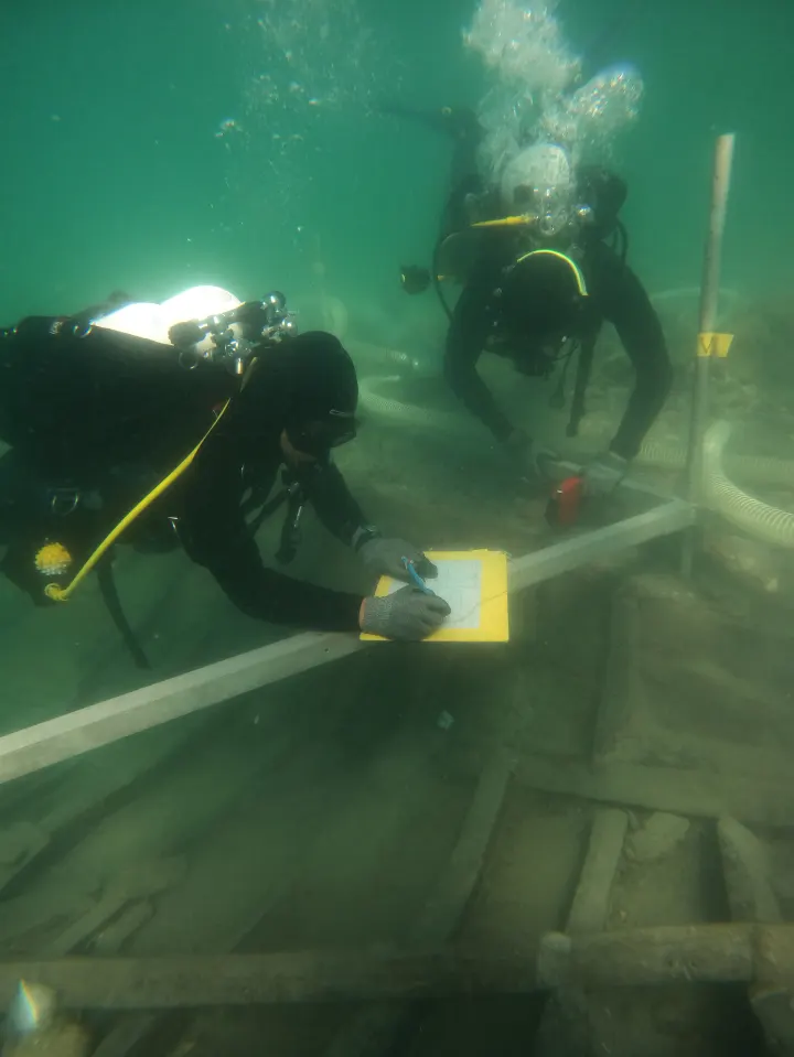 Two divers examining an ancient Roman shipwreck.