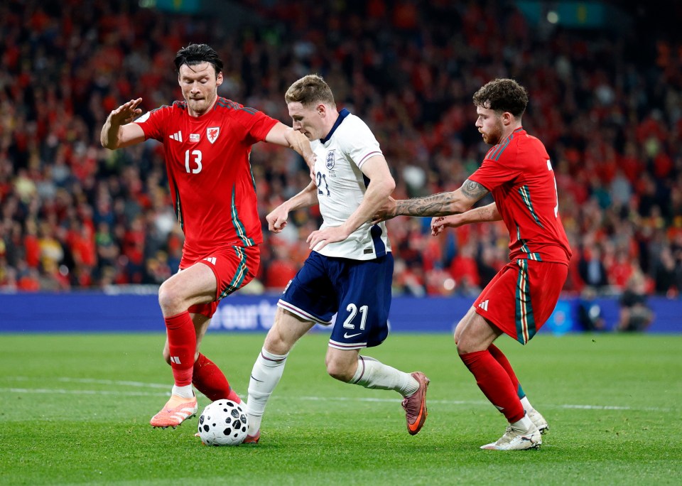 England's Elliot Anderson in action with Wales' Kieffer Moore and Neco Williams during an international friendly football match.