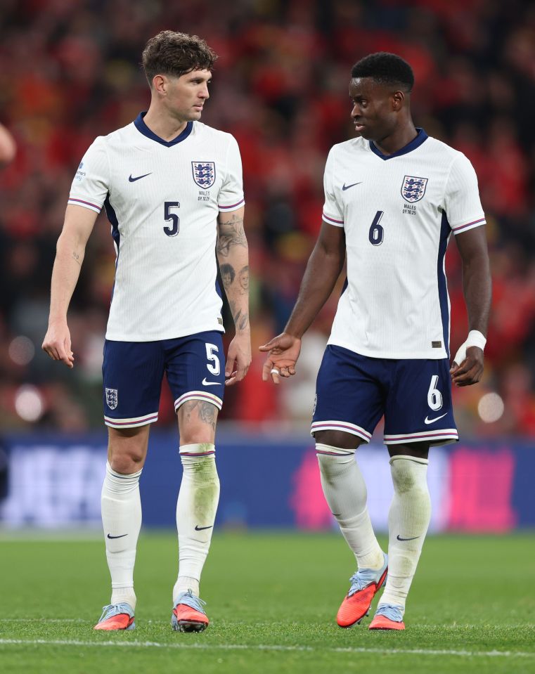 John Stones and Marc Guehi of England on the field.