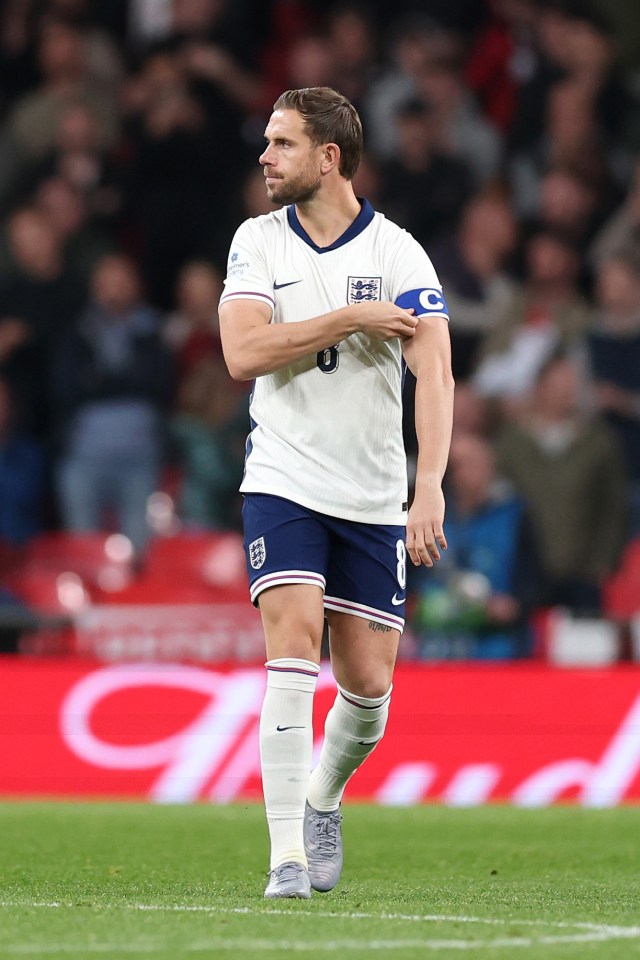Jordan Henderson of England puts on the captain's armband.