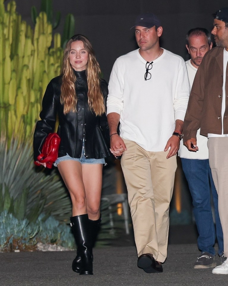 Sydney Sweeney and Scooter Braun holding hands.