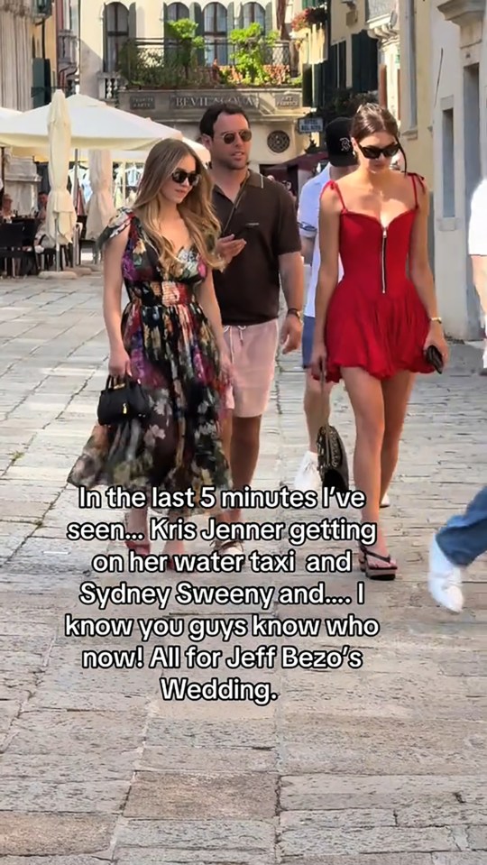 Sydney Sweeney and Vittoria Ceretti walking down a street in Venice.