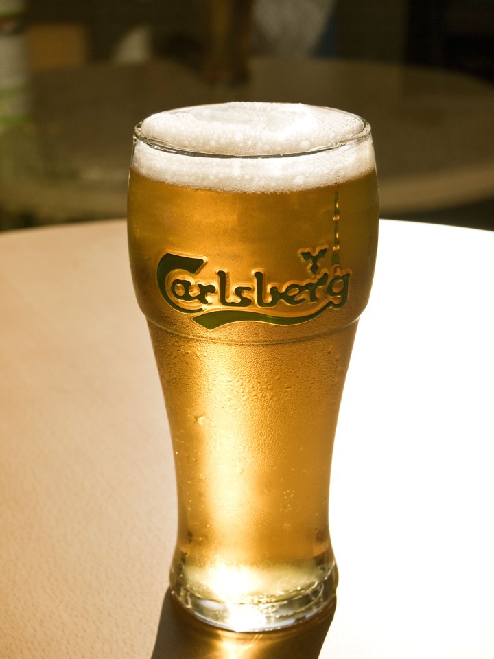 A glistening pint of cold Carlsberg lager beer.