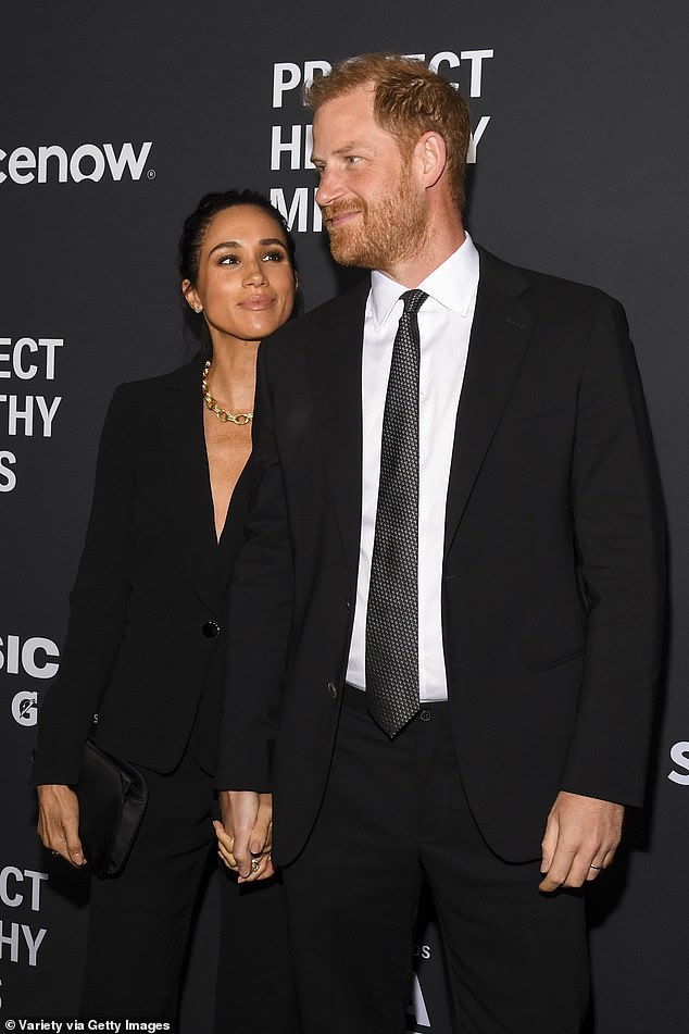 Meghan stares adoringly at her husband