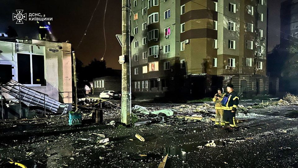 Firefighters at a residential building in Kyiv damaged by an overnight Russian missile strike.