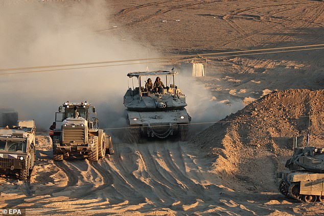 Israeli tanks arrive at a gathering site after withdrawing from the Gaza Strip