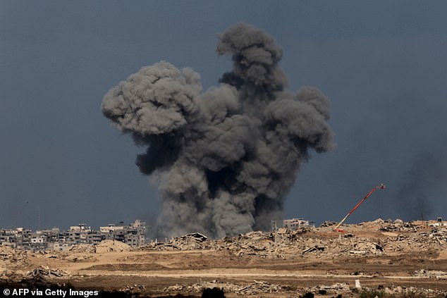 A smoke plume billows following Israeli bombardment on the Gaza Strip as pictured from across the border in southern Israel on October 10, 2025