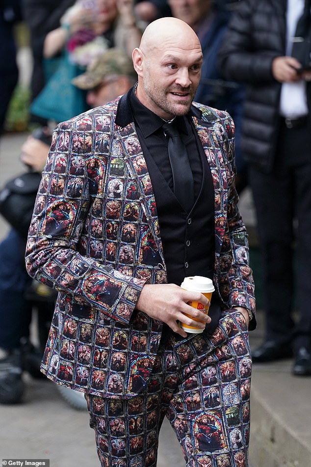 Toting a McDonalds coffee, Fury showed off his matching suit and pants, with images depicting him on a throne wearing a crown