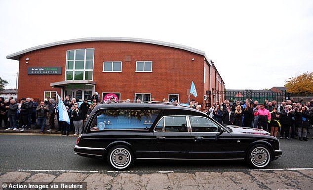 The cortege stops outside Hatton's Gym in Hyde during the procession this morning