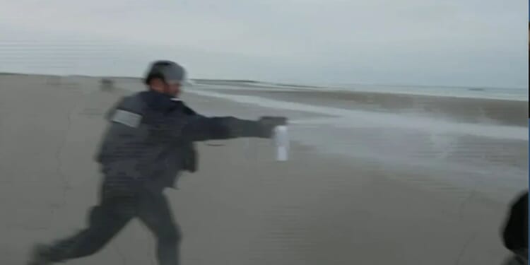 Moment bungling French cops fail to stop migrants with pepper spray… before watching as they sail away AGAIN – The Sun