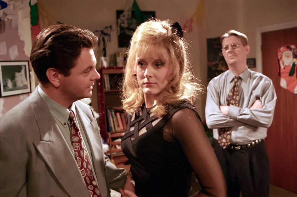 Des Barnes and Raquel Wolstenhulme at Curly and Raquel's engagement party, with Curly Watts in the background.