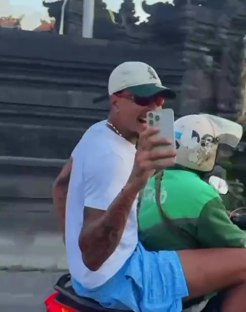 Dele Alli taking a selfie while riding on the back of a motorcycle in Bali.