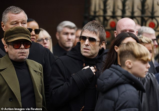 Mani from the Stone Roses and Oasis star Liam Gallagher leave Manchester Cathedral today