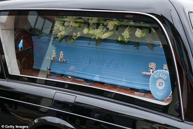 The coffin is seen with the engraving 'Blue Moon' and the Manchester City FC crest today