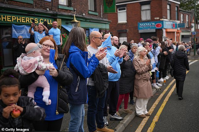Members of the public pay their respects as the funeral cortege of Ricky Hatton passes today