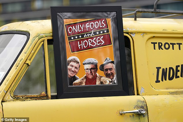 A mock-up of Hatton as Del Boy on the side of the Reliant Robin at Manchester Cathedral today