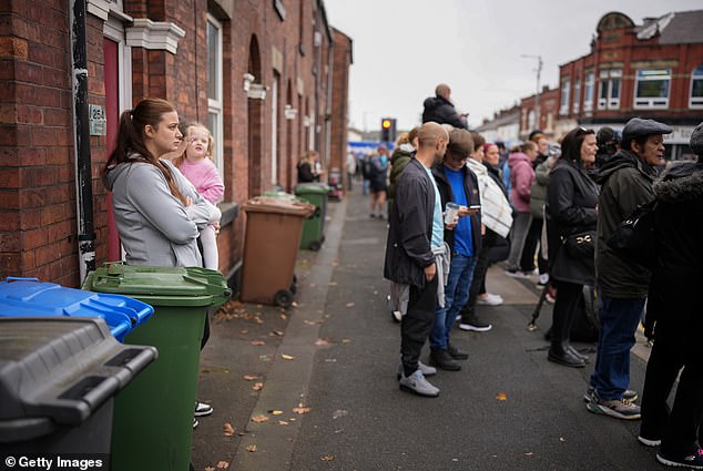 Members of the public pay their respects as the funeral cortege of Ricky Hatton passes today