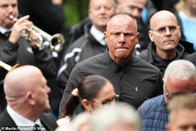 Former Manchester City footballer Andy Morrison arrives ahead of the funeral service today