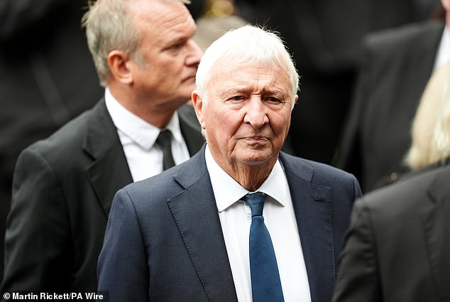 Former Manchester City footballer Mike Summerbee arrives ahead of the funeral service today