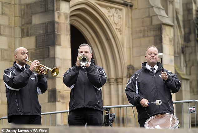 Members of the Hatton band play outside Manchester Cathedral ahead of the funeral today