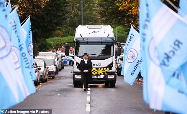 Manchester City flags on the route of the funeral cortege for Ricky Hatton this morning