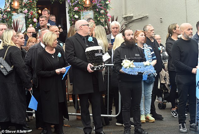 Mourners outside the Cheshire Cheese pub - Hatton's local - on Stockport Road in Hyde