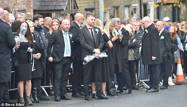 Mourners outside the Cheshire Cheese pub - Hatton's local - on Stockport Road in Hyde