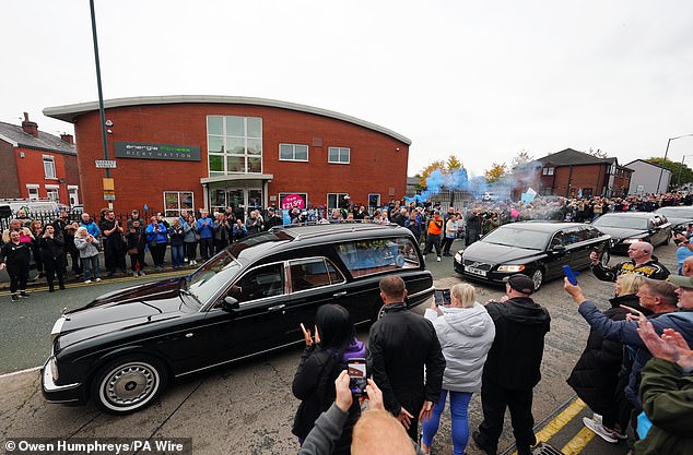 The cortege stops outside Hatton's Gym in Hyde during the procession this morning