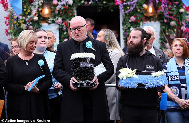 Mourners outside the Cheshire Cheese pub - Hatton's local - on Stockport Road in Hyde