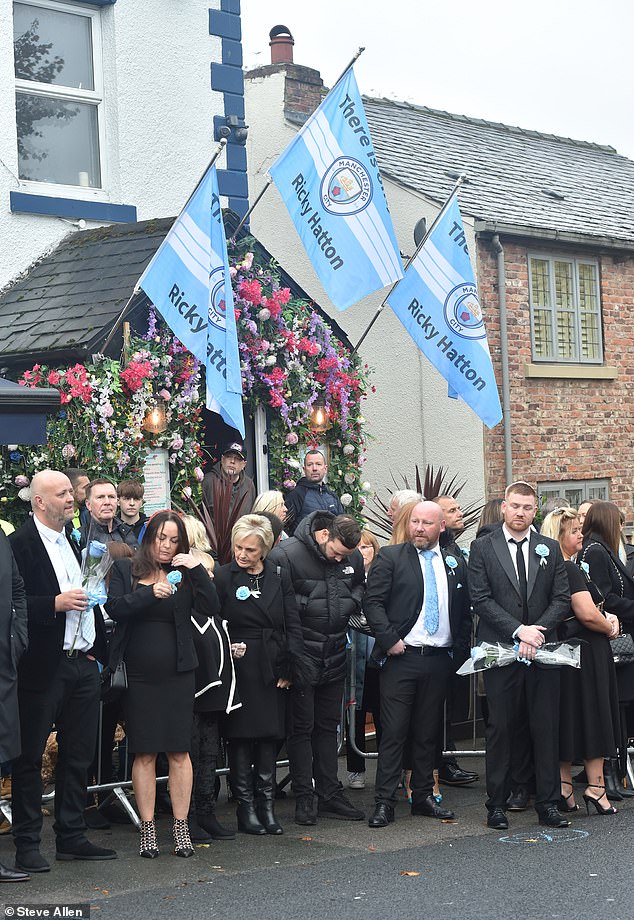 Mourners outside the Cheshire Cheese pub - Hatton's local - on Stockport Road in Hyde