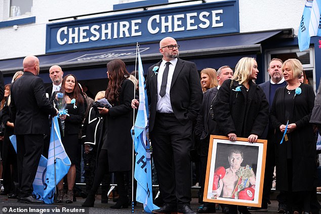 Mourners outside the Cheshire Cheese pub - Hatton's local - on Stockport Road in Hyde