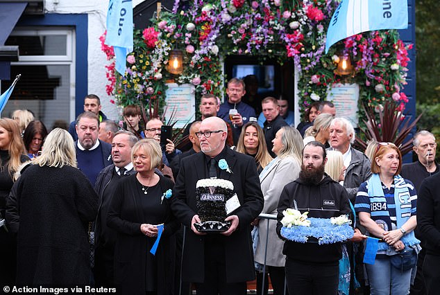 Mourners outside the Cheshire Cheese pub - Hatton's local - on Stockport Road in Hyde