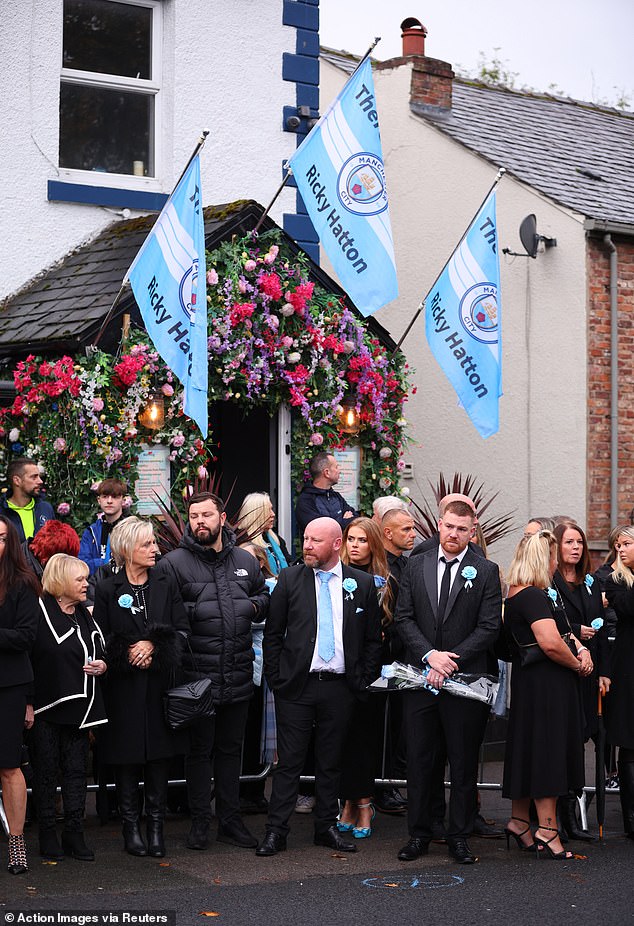 Mourners outside the Cheshire Cheese pub - Hatton's local - on Stockport Road in Hyde