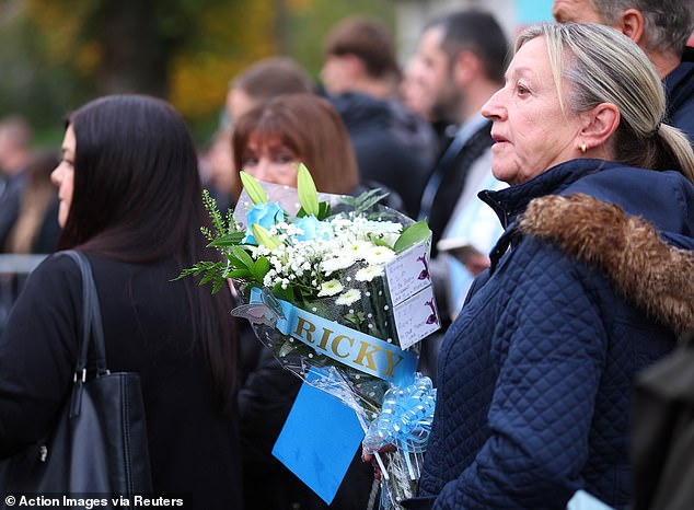 Mourners outside the Cheshire Cheese pub - Hatton's local - on Stockport Road in Hyde